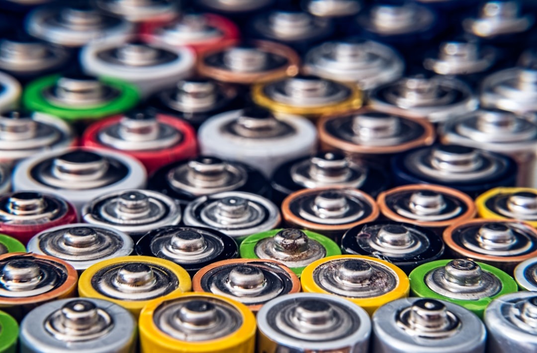 A collection of colorful AA or AAA batteries arranged together.