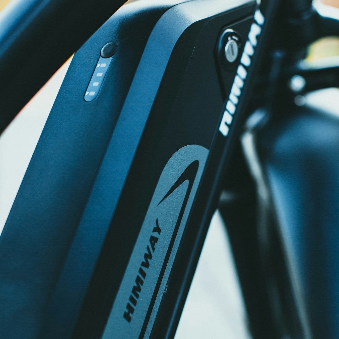 Himiway electric bicycle battery with a glowing charge indicator.